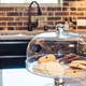 Cookies under glass dome on kitchen counter